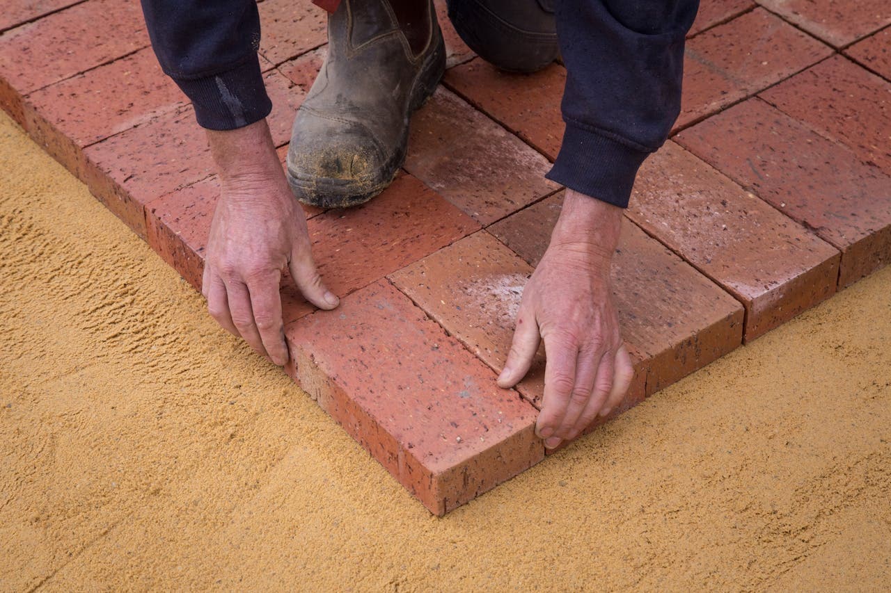 Mason carefully laying bricks on a residential project in Central Virginia