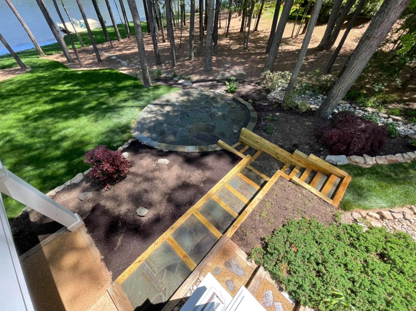 Crew finishing a fresh concrete pour with a bull float on a sunny Virginia jobsite