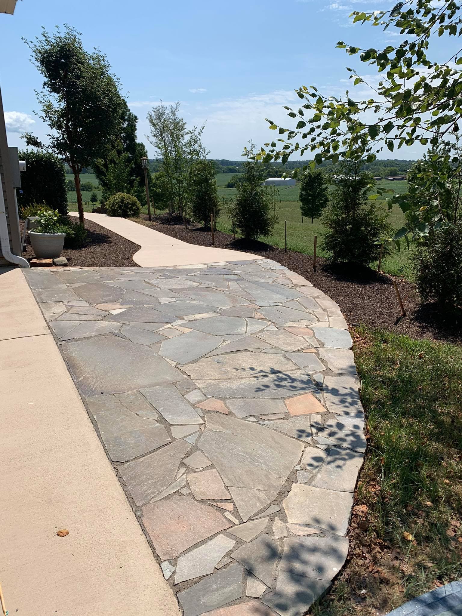 Stone paver patio with neat edging next to a home